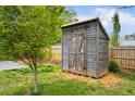 Rustic shed in backyard with double doors, providing extra storage space at 1420 Elizabeth Ln, East Point, GA 30344
