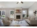 Cozy living room featuring a fireplace, neutral furniture, and an open layout at 11370 Ridge Hill Dr, Alpharetta, GA 30022