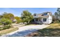 Beautiful home on a tree-lined street featuring a large driveway and manicured lawn at 2620 Oak St, Atlanta, GA 30344