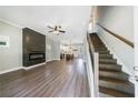 Open-concept living room featuring hardwood floors, a fireplace, and access to the kitchen at 2620 Oak St, Atlanta, GA 30344