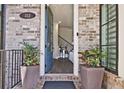 Inviting entryway with stylish brick accents, plants, and an open door view at 312 Concord St, Alpharetta, GA 30009