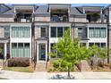 Charming townhome with a private balcony, brick facade, and lush greenery at 312 Concord St, Alpharetta, GA 30009
