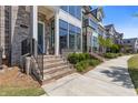 Inviting townhouse featuring a brick facade, manicured lawn, and cozy entrance at 312 Concord St, Alpharetta, GA 30009