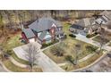Brick two-story home with attached garage, long driveway, and well-maintained lawn at 7090 Blue Sky Drive, Locust Grove, GA 30248