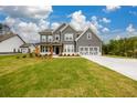 Charming two-story home with gray siding and a well-maintained lawn and driveway at 8245 Dawson View Way, Cumming, GA 30028