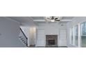 Bright living room featuring coffered ceilings, stone fireplace, and lots of natural light at 8245 Dawson View Way, Cumming, GA 30028