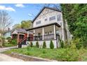 Exterior view of a two-story house with a cozy front porch and neatly trimmed shrubs, showcasing curb appeal at 1115 Martin Luther King Jr Sw Dr, Atlanta, GA 30314