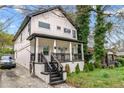 Exterior shot featuring a two-story home with black and white accents, a charming porch, and well-maintained landscaping at 1115 Martin Luther King Jr Sw Dr, Atlanta, GA 30314