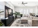 Spacious living room featuring lots of windows and natural light, hardwood floors, and modern decor at 3905 Danube Ln # 215, Atlanta, GA 30339