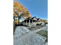 View of the house with covered front porch, brick foundation, and a driveway at 698 Ira St, Atlanta, GA 30310