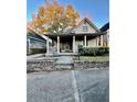 Inviting home with a brick foundation and a cozy front porch with columns at 698 Ira St, Atlanta, GA 30310
