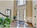 Bright foyer with hardwood floors, high ceilings, a decorative rug and an elegant front door at 865 Mount Katahdin Trl, Johns Creek, GA 30022
