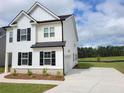 Beautiful two-story home with a spacious driveway and manicured front yard at 354 Friendship Oak Way, Hampton, GA 30228
