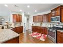 The spacious kitchen has granite counters, stainless steel appliances, and warm wood cabinets, creating an inviting space at 3613 Lake Estates Way, Atlanta, GA 30349