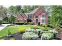 Beautiful brick home boasting meticulous landscaping and a charming, traditional facade at 955 Bishopswood Pl, Johns Creek, GA 30022