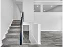 Spacious foyer with staircase, gray plank flooring, and bright lighting for a modern, inviting entry at 175 Montego Cir, Riverdale, GA 30274