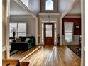 Open foyer with hardwood floors, high ceilings, and a decorative glass front door at 5717 Harmony Point Dr, Lilburn, GA 30047