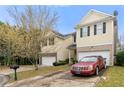 Well-kept two-story home featuring an attached garage and lush greenery at 6389 Shadow Sq, Lithonia, GA 30058