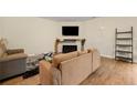 Comfortable living room with a sleek entertainment center, hardwood floors, and neutral decor at 6389 Shadow Sq, Lithonia, GA 30058