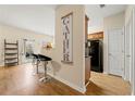 Open-concept space with breakfast bar, seamlessly connecting the living area and kitchen at 6389 Shadow Sq, Lithonia, GA 30058