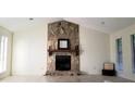 Bright living room featuring a stone fireplace, vaulted ceilings, and neutral color palette at 849 Cadet Nw Ct, Lilburn, GA 30047