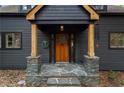 Close-up of the front door with stone accents, a wreath, and a charming entrance at 1890 Spalding Dr, Atlanta, GA 30350