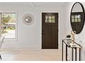 Bright foyer with a decorative mirror, modern table, and a view to the outside at 244 Birch St, Atlanta, GA 30354