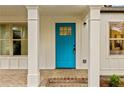 A close-up of the bright blue front door with sidelight windows and brick platform at 244 Birch St, Atlanta, GA 30354