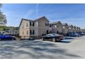 Street view of the townhome complex showing a row of townhomes and a parking lot at 3938 Stillwater Dr, Duluth, GA 30096
