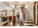 Grand foyer with hardwood floors, a staircase, and elegant trim throughout at 1285 Wesley Nw Pl, Atlanta, GA 30327