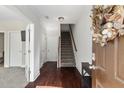 Bright foyer features hardwood floors, staircase, and decorative accents at 3920 High Dove Sw Way # 11, Smyrna, GA 30082