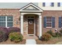 Charming brick entryway with decorative wreath and covered porch at 3920 High Dove Sw Way # 11, Smyrna, GA 30082