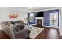 Comfortable living room with fireplace, tv, neutral colored sofa, and dark wood floors at 3920 High Dove Sw Way # 11, Smyrna, GA 30082