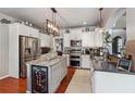 Stylish kitchen featuring white cabinetry, stainless steel appliances, and a granite island with wine storage at 4030 Gold Mill Rdg, Canton, GA 30114