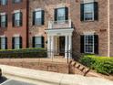 Charming brick condo with black shutters, white trim, and landscaped entrance stairs at 4955 Ivy Ridge Se Dr # 404, Atlanta, GA 30339