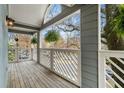 Inviting balcony with diagonal white railings, wooden floor, and hanging plants for a cozy outdoor space at 708 Mcgill Ne Pl, Atlanta, GA 30312