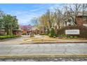 Community entrance with stone signage, manicured landscaping, and a gated entry at 708 Mcgill Ne Pl, Atlanta, GA 30312