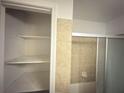 Bathroom with tiled shower/tub and open shelving at 2414 West Rd, Riverdale, GA 30296
