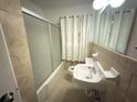 Bathroom featuring a vanity sink and tiled shower-tub combo at 2414 West Rd, Riverdale, GA 30296
