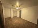 Bedroom with ceiling fan, closet, and neutral carpet at 2414 West Rd, Riverdale, GA 30296