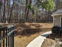 Enjoy the tranquility of this home’s backyard with its tiered landscape and secure black fence at 1074 Deshon Trl, Lithonia, GA 30058