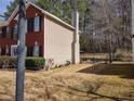 View of the home's exterior and fenced-in backyard, creating a private and secure outdoor space at 1074 Deshon Trl, Lithonia, GA 30058