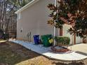 This property boasts a neat walkway, leading to a fenced backyard, with fresh gravel and tidy landscaping at 1074 Deshon Trl, Lithonia, GA 30058