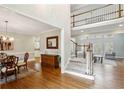 Inviting foyer with hardwood floors, staircase, and view into the living room at 2283 Edgemere Lake Cir, Marietta, GA 30062