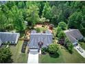 Aerial view of a single-Gathering home with lush landscaping, fenced backyard, and a long driveway at 29 Fern Leaf Ct, Dallas, GA 30157