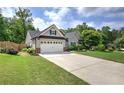 A charming single-Gathering home with well-maintained lawn, a driveway, and an attached two-car garage at 29 Fern Leaf Ct, Dallas, GA 30157