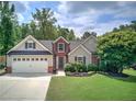 Charming two-story home featuring a brick facade, gray siding, well-manicured lawn, and an attached two-car garage at 29 Fern Leaf Ct, Dallas, GA 30157