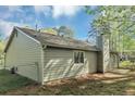The rear of the house shows vinyl siding, a small patio, and fenced yard at 5477 Hedgeflower Ct, Stone Mountain, GA 30088