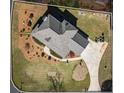 An aerial view showcasing a landscaped yard, circular drive and well-maintained property at 9549 Clear Lake Court, Douglasville, GA 30135