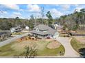 Stunning home with a large wraparound porch, well-kept lawn, and a spacious driveway at 9549 Clear Lake Court, Douglasville, GA 30135